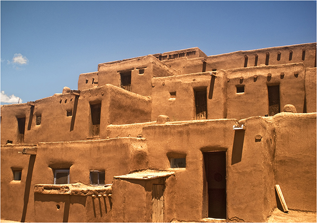 Photo 1.6, “Taos Pueblo,” is a contemporary color photograph of the oldest city in the United States, taken on a clear day by photographer Jim Feliciano.